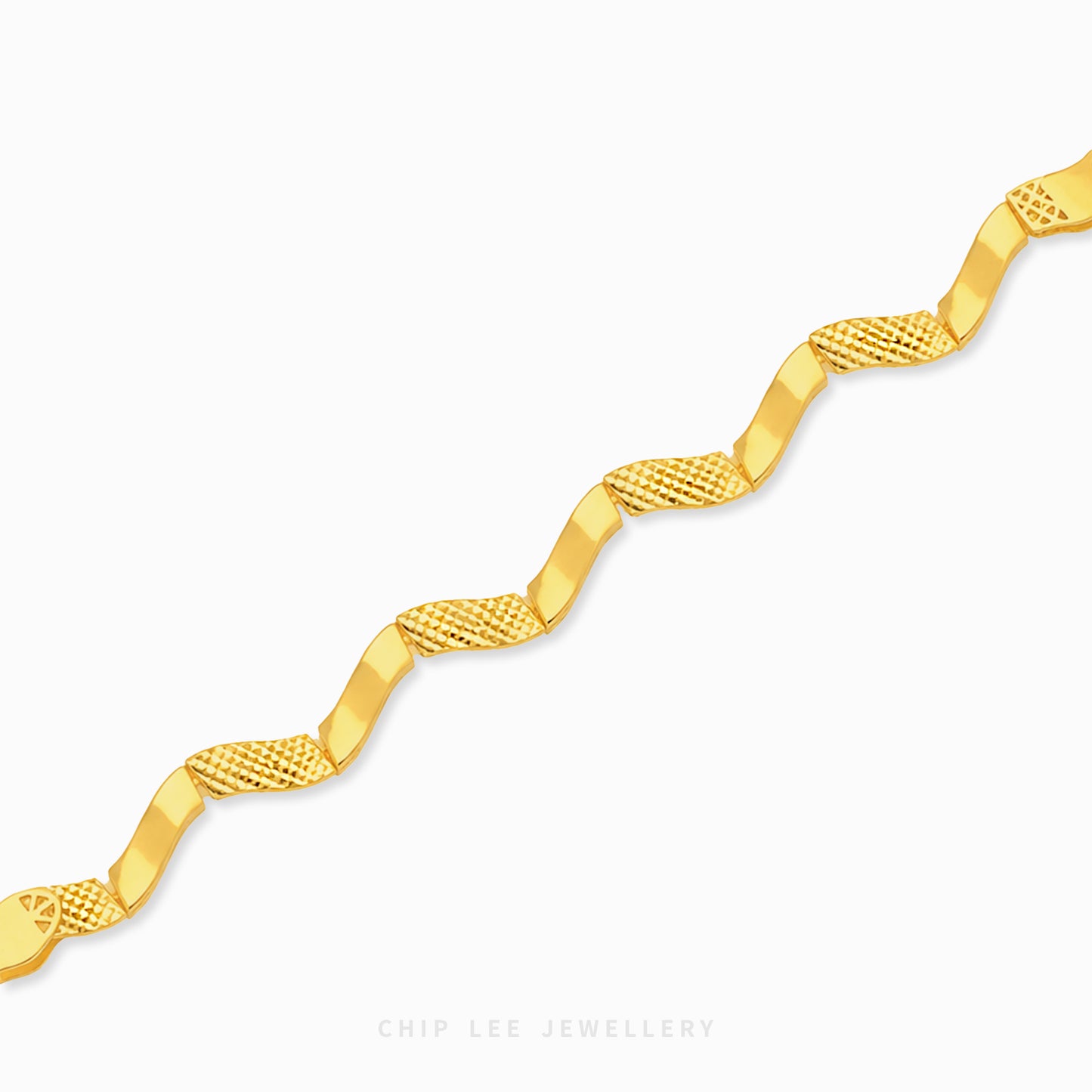 A gold chain bracelet with a wavy, zig-zag design featuring alternating smooth and textured diamond-patterned links, shown on a light gray background with a Chip Lee Jewellery watermark.