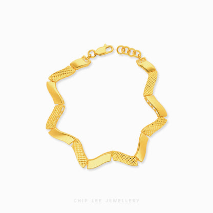 A gold chain bracelet with alternating smooth and textured links, displayed on a clean white background with a Chip Lee Jewellery watermark at the bottom.