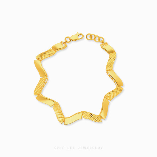 A gold chain bracelet with alternating smooth and textured links, displayed on a clean white background with a Chip Lee Jewellery watermark at the bottom.